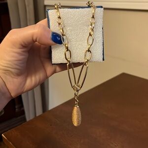 Gold costume jewelry with center pendant.